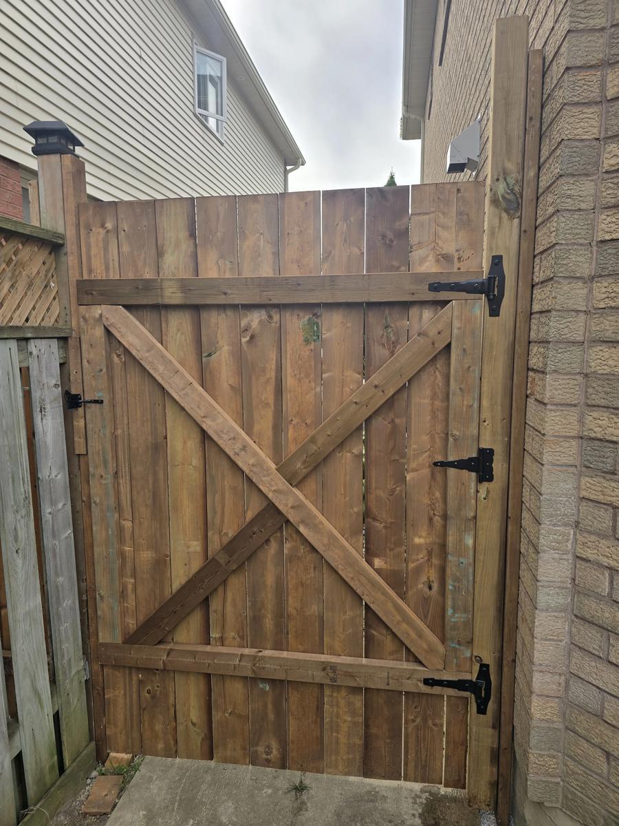 Finished stained wood fence gate with hardware